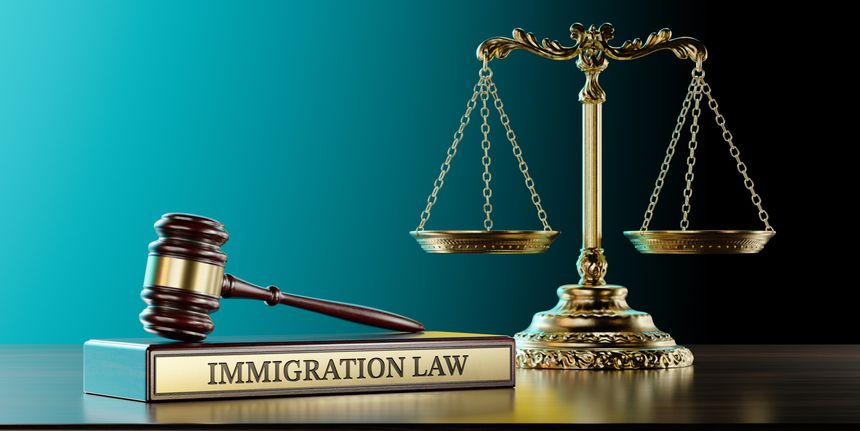 Immigration Law: Judge's Gavel as a symbol of legal system, Scales of justice and wooden stand with text word.