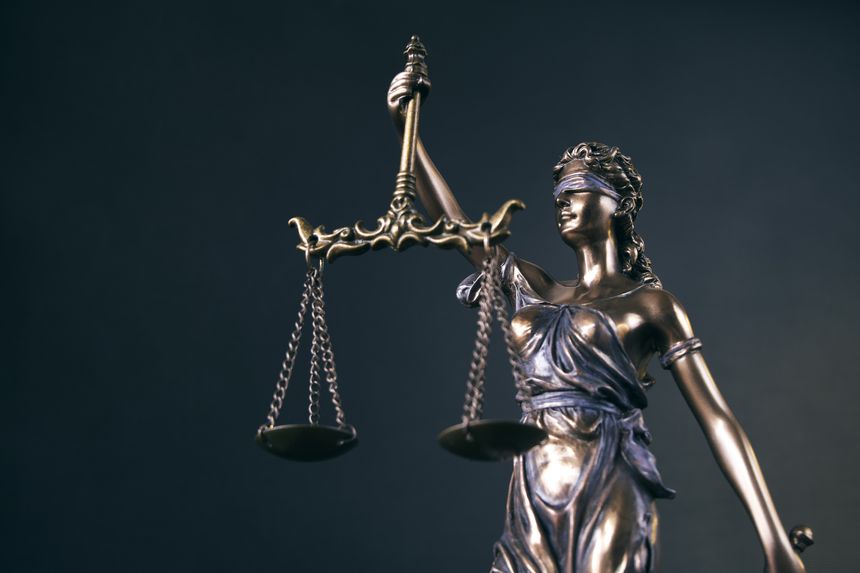 Statue of Themis Lady of Justice symbol on black background