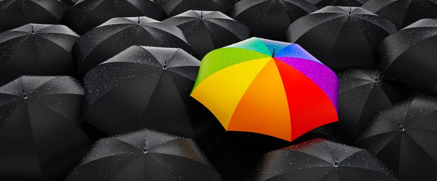 Crowd of black umbrellas with one unique rainbow colored outstanding umbrella - 3d illustration