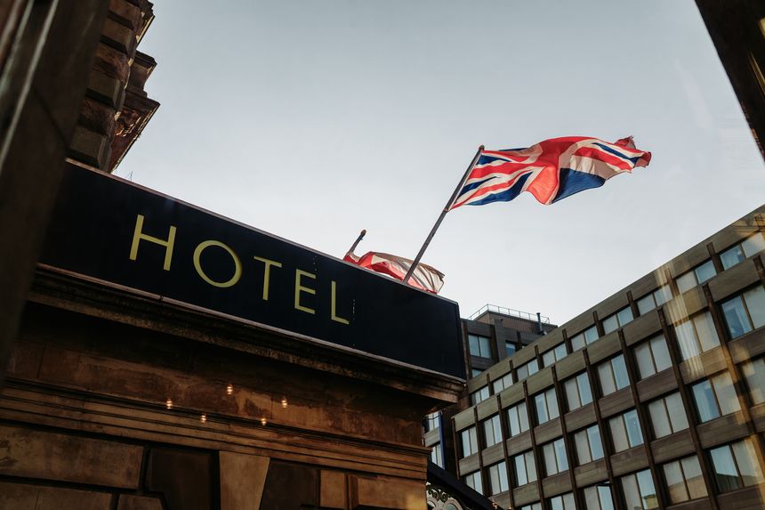 Newcastle upon Tyne UK: 2nd Aug 2025: Union Jack flag waves over a hotel in a city during clear weather with buildings rising behind