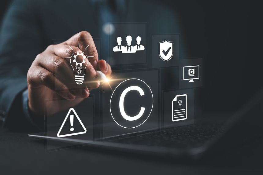 Business people work through laptops, concepts of copyright or intellectual property patents, piracy protection, proprietary representation, legitimate innovations and inventions, patent campaigning.