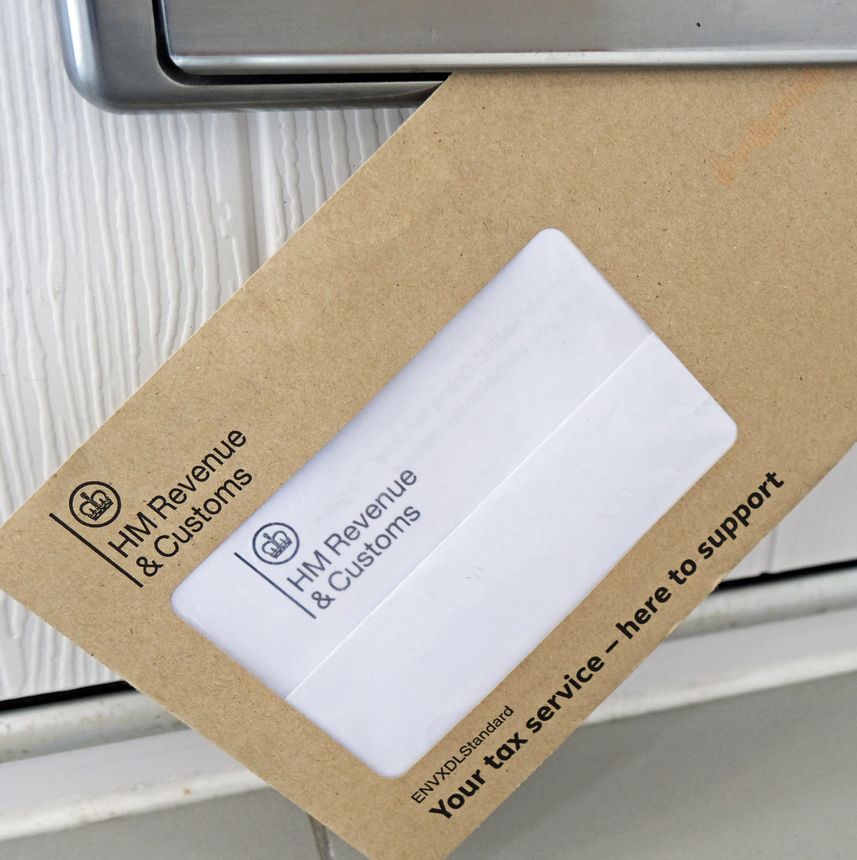 Billericay, Essex, United Kingdom, April 10, 2026. Brown envelope tax demand from HM Revenue and Customs coming through mail box in door. Studio shot