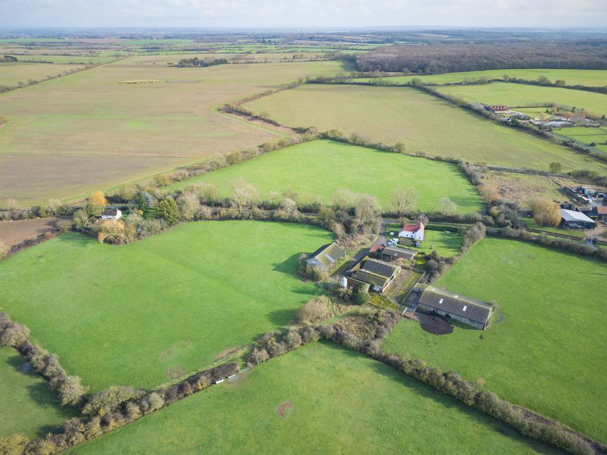 Interesting UAV view of a once busy dairy farm seen during a sunny. morning in Blackmore, Essex, UK. Various outbuildings can be seen on the brownfield area. An adjoining farmhouse is in the top centre of the image.