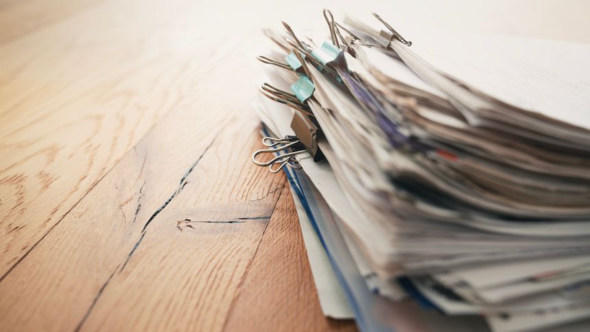 Pile of paperwork on office desk