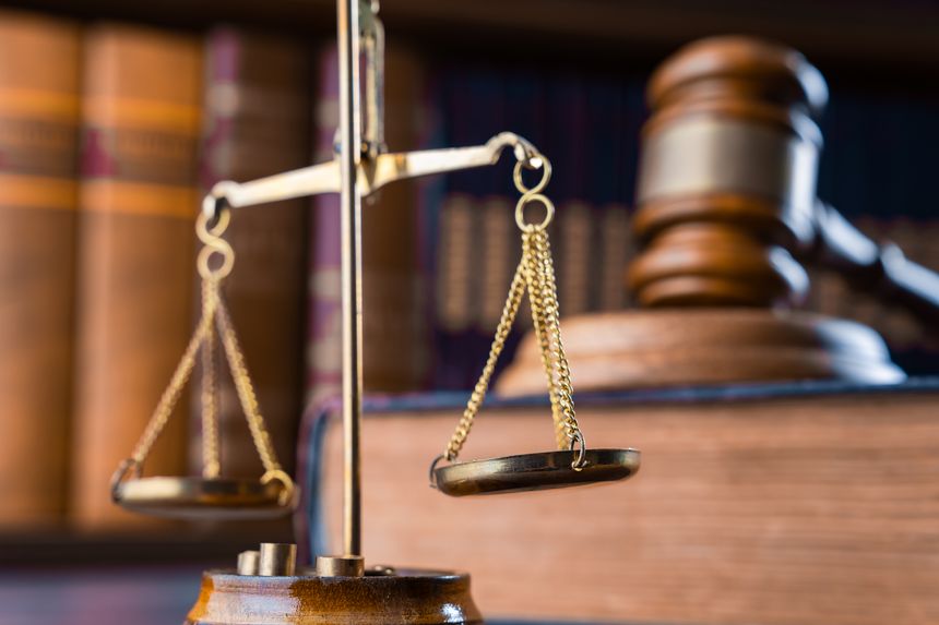 Judge's gavel on book and scales in law office, archives, legal concept