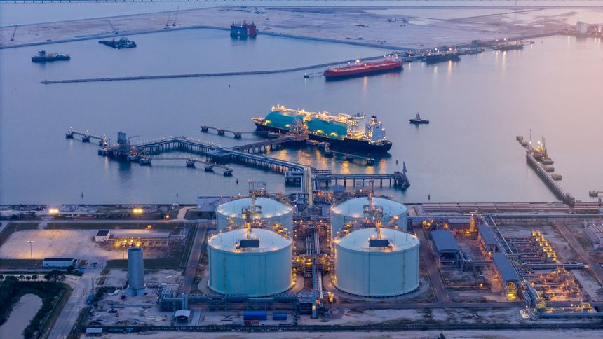 LNG (Liquified Natural Gas) tanker anchored in Gas terminal gas tanks for storage. Oil Crude Gas Tanker Ship. LPG at Tanker Bay Petroleum Chemical or Methane freighter export import transportation
