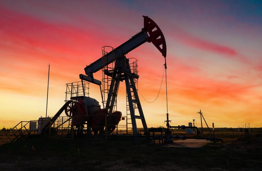 Pumpjack in oil well of oil field on sunset in Industrial crude area. Crude pump jack working on oil field. Pumpjack, Oil drill rig, drilling derrick in oilfield. Natural gas, Crude petroleum industry