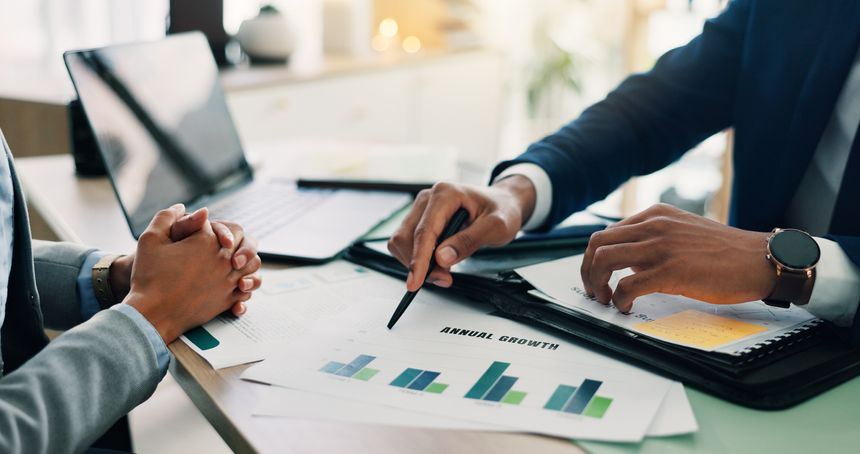 Business people, hands and documents with laptop or statistics for company profit, growth or graph at office. Closeup, employees or analyst pointing with chart for financial revenue or performance