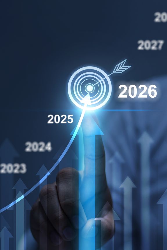 A businesswoman analyzes the profitability of operating companies using digital graphs, positive trends for 2026,New Business Plan Setting Goals for the New Year 2026, businessman using laptop and tablet to strategize and develop the organization to grow to success in 2026, finding business opportunities.