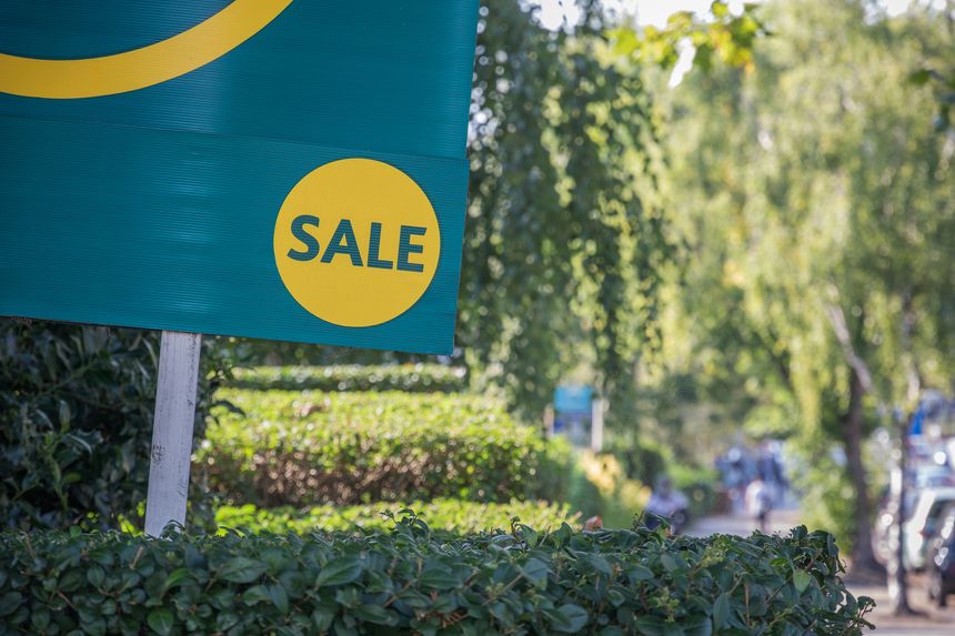 Estate agents for sale sign displayed on London street