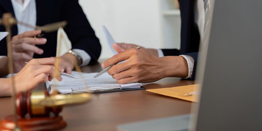 Close-up of hands interacting with legal documents, highlighting the meticulous nature of legal work and the importance of detail.