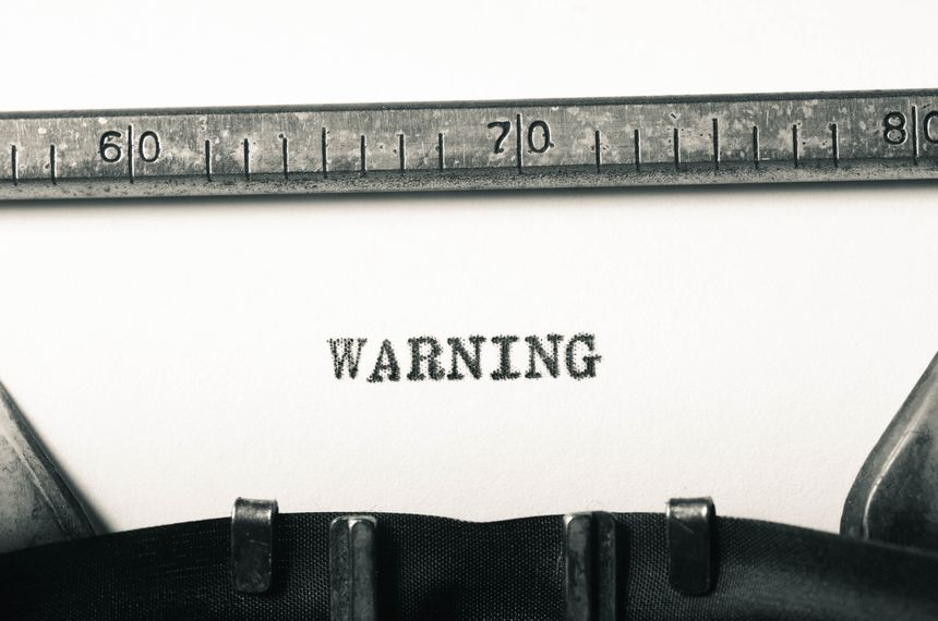 word warning typed on old typewriter