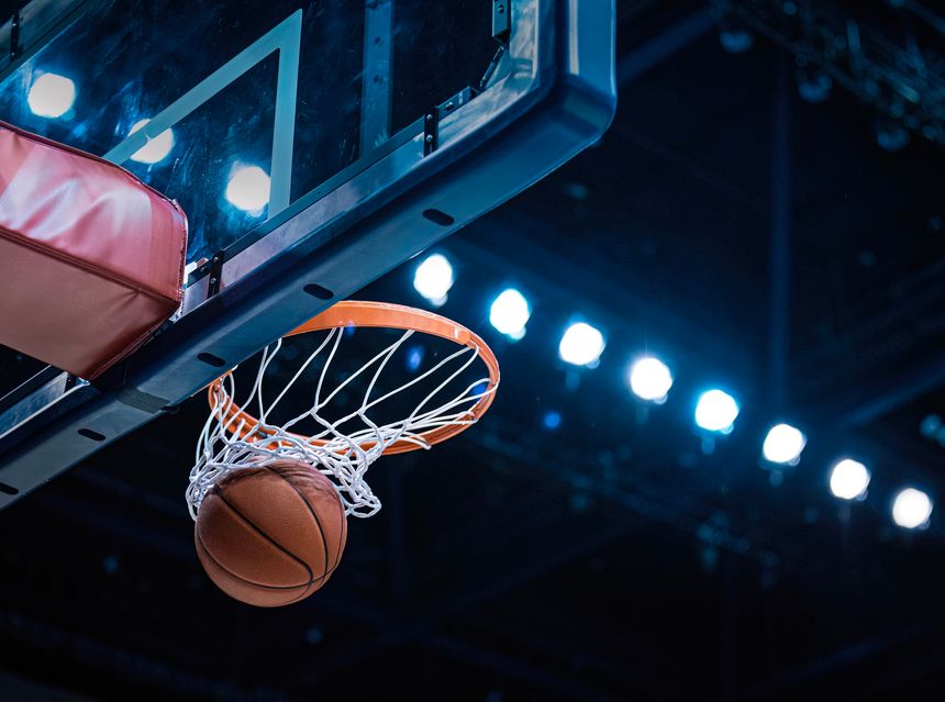 Basketball scoring a basket as it goes through the hoop and making a swish in the net. Good basketball concept photo