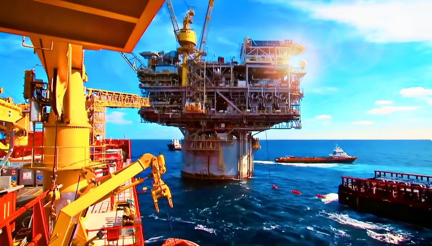 Aerial view of modern offshore oil drilling platform operating in the open sea with support supply vessels nearby. The image highlights the energy sector, petroleum exploration, marine engineering, and industrial infrastructure essential for global oil and gas production. Perfect for themes of energy, fossil fuels, offshore operations, marine logistics, and industrial development.