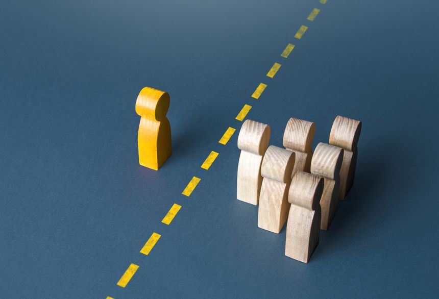 A person and a group of people are separated by a yellow line. Establishing contact. Distrust. Quarantine. Distance with strangers. Barrier to understanding, difficult integration. Rejection, refusal.