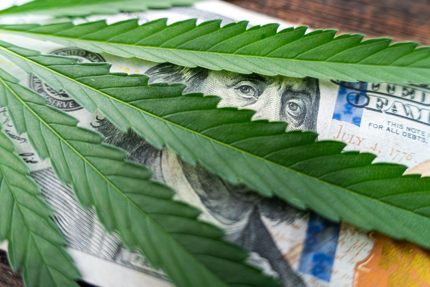 Cannabis medical marijuana leaf on one hundred dollar bills. sheet of marijuana for money, dollars and cannabis, a legal and black market business.