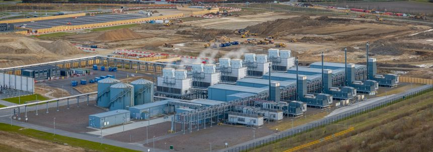 Data center and computing facility with cooling units, processing buildings and interconnected technical infrastructure with visible cooling systems release vapor, indicating active thermal management