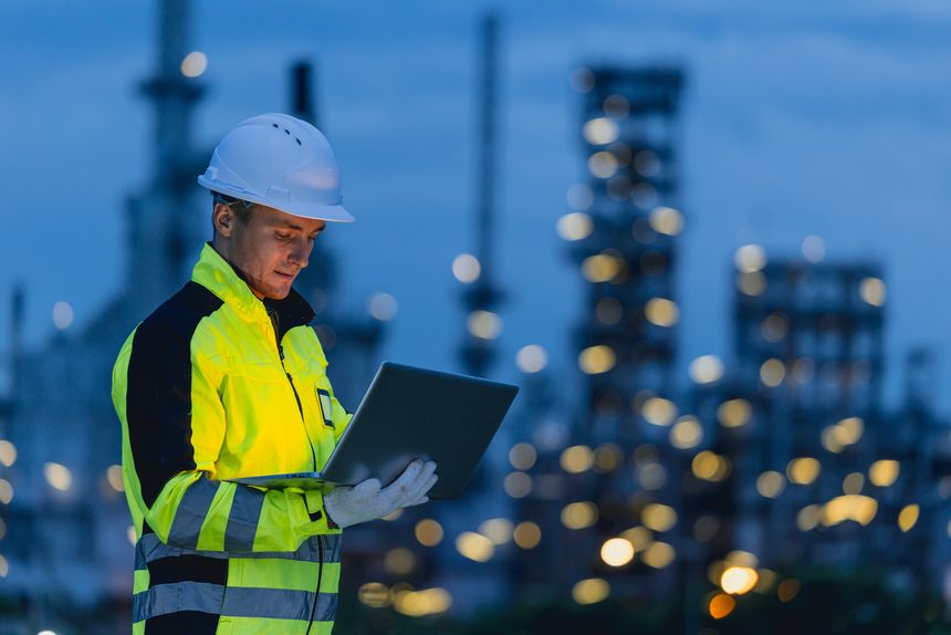Engineer man technician male working at night shift with tablet technology device on site service with copy space for text