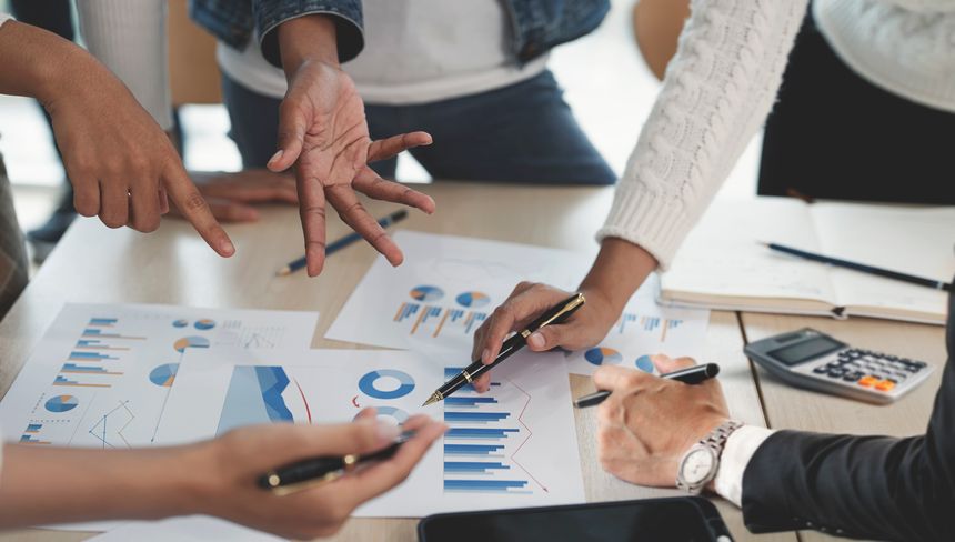Cropped shot of diverse coworkers working together in boardroom, brainstorming, discussing and analyzing business strategy.