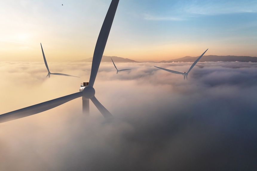 Wind turbine emerging above morning clouds with sunrise light, symbolizing clean energy, renewable power and a sustainable future landscape