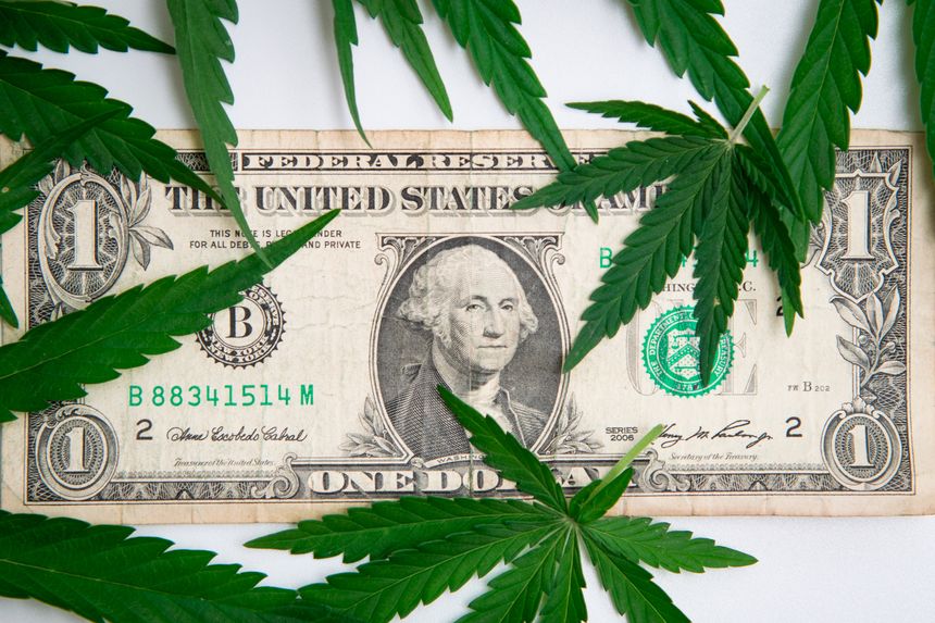 One dollar and cannabis leafs