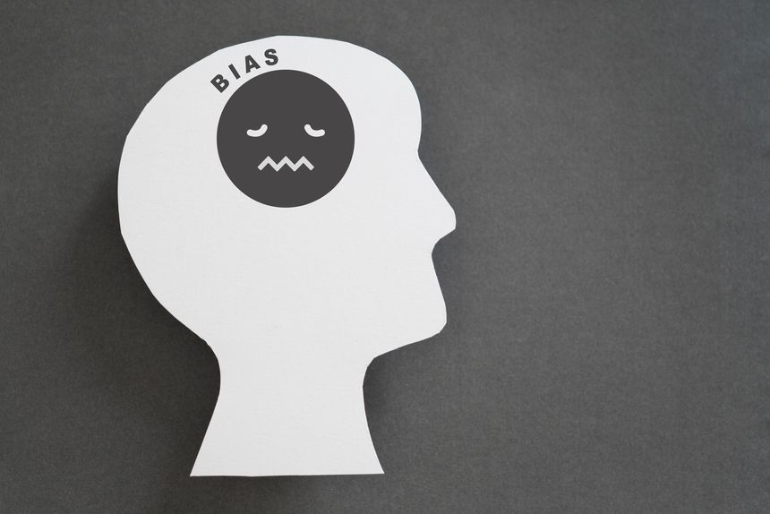 human head real white paper cut with unhappy face icon and bias text on grey background