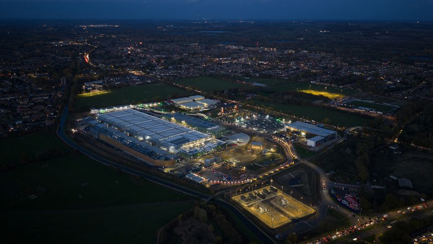 performance, speed, microservices, containerization, and the massive scale Hyperscale driving data center demand for cloud native applications. Aerial view at night.