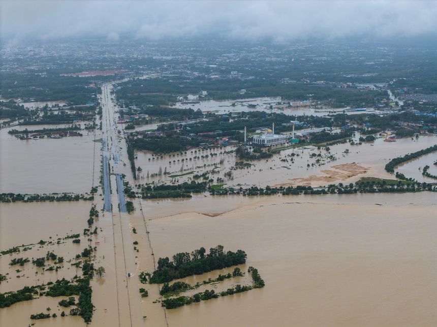 Hatyai,Thailand-25Nov2025:Lupburi Ramesuan Road (Hat Yai, Thailand) submerged by severe flooding. An aerial view shows the multi-lane highway under turbid brown water.