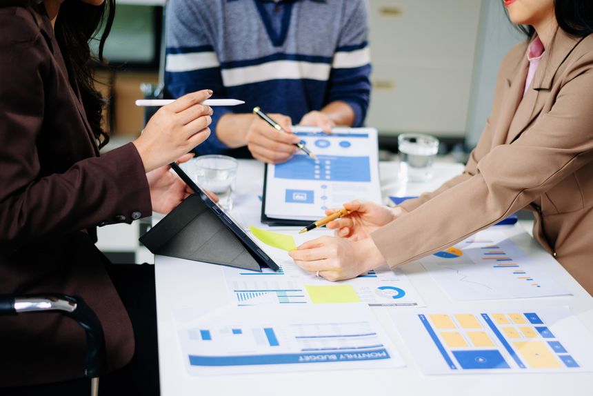 Businessman and team analyzing financial statement Finance task. with smart phone and laptop and  tablet. Wealth management concept
