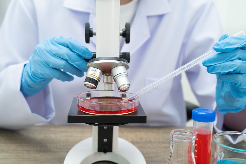 Scientist medical professional use microscope for research in science laboratory.