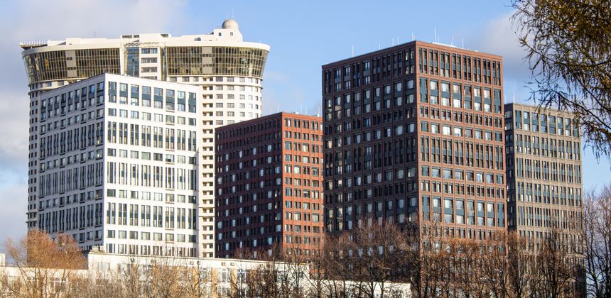 Large beautiful modern buildings are designed with lots of windows to showcase urban architectural design and public life.
