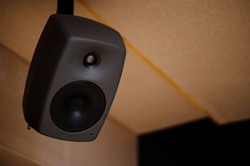 Close-up of a Hanging Speaker Mounted on the Ceiling in an Indoor Setting