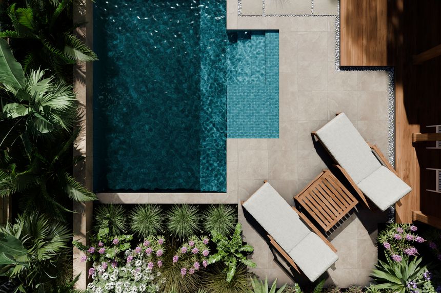 Aerial view of luxury swimming pool design and garden landscaping. Modern beach house architecture with tropical palms and trendy aesthetic materials natural stones and concrete tiles. Top view. Private hotel villa resort rental concept. 3d render
