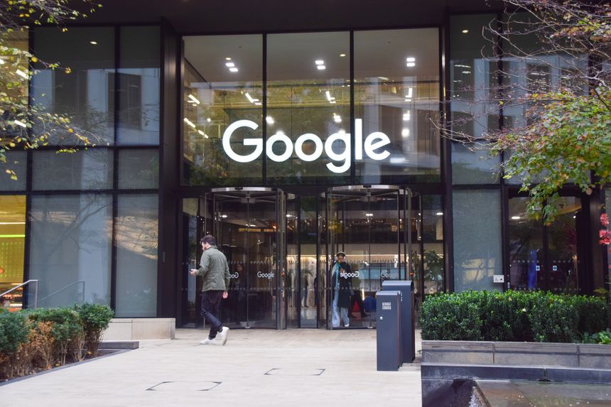 London, UK - October 10 2025: a person walks outside Google headquarters in Pancras Square, King's Cross