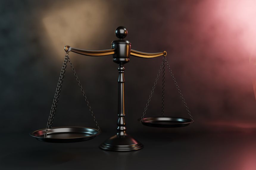 Black scales of justice on black background with some colorful spotlight effect. Illustration as copy space for website templates and slide show presentations