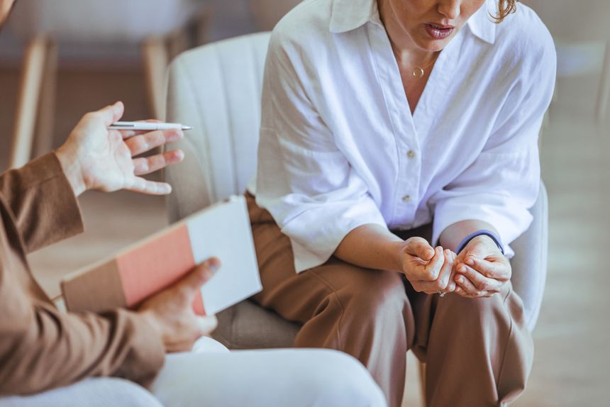 A counseling session with a therapist interacting empathetically with a client, promoting communication, trust, and emotional understanding. Depicts human connection and self-reflection in a supportive therapeutic environment.
