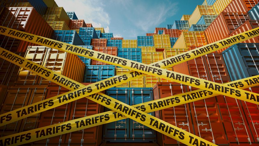 A stack of colorful shipping containers restricted by yellow tape labeled tariffs. Represents global trade challenges, import-export restrictions, and economic impacts of international tariff policies.