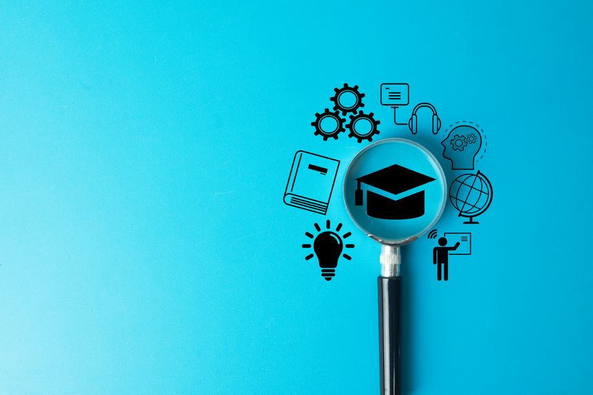 E-learning and online education concept. A magnifying glass focuses on a graduation cap surrounded by icons for study, knowledge, and digital courses, representing modern skill development.