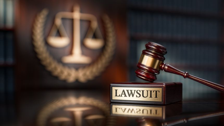 Lawsuit: Judge's Gavel as a symbol of legal system and wooden stand with text word.