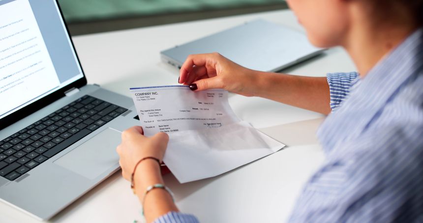 Woman In Office Managing Payroll Compensation Check Envelope With Care.