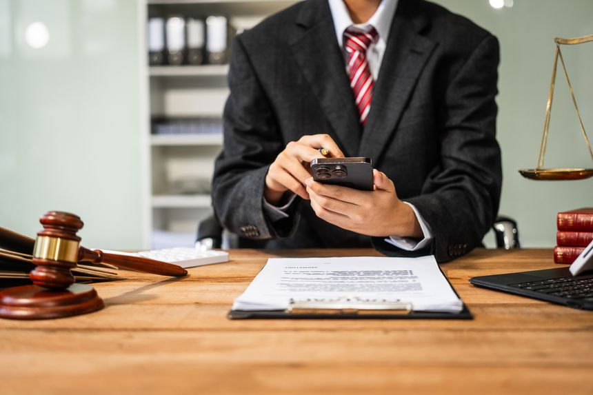 A young businesswoman is working at her desk, diligently preparing legal briefs and reviewing evidence for an upcoming trial, demonstrating her expertise as a lawyer in litigation and advocacy.