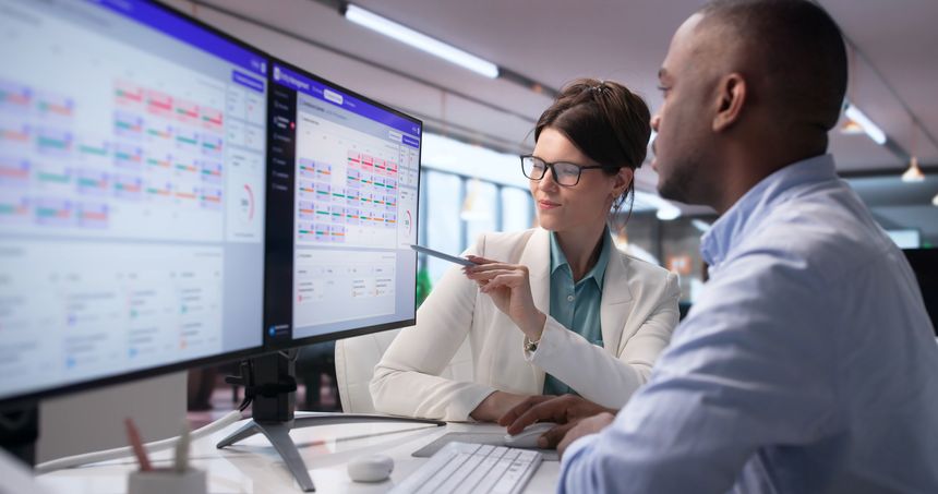 Two Corporate Leaders Discuss Company Ownership Chart On Laptop Screen.