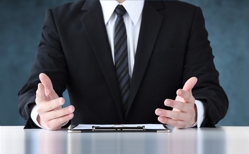 Talking businessman on dark blue background