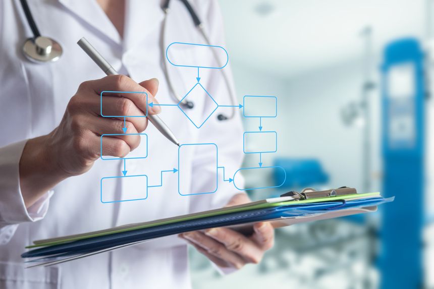 Health professional creating a care plan in a hospital setting. A dedicated doctor designs a patient care plan using a pen and clipboard in a bright hospital.
