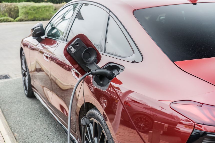 Stoke, Staffordshire, England, December 29th 2025. A close-up of a red Audi A6 getting charged by a plug.