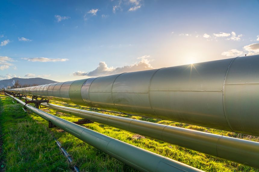 Pipelines of a geothermal power plant at sunset in Larderello, Tuscany region, Italy. Geothermal power is a form of alternative and sustainable energy production.