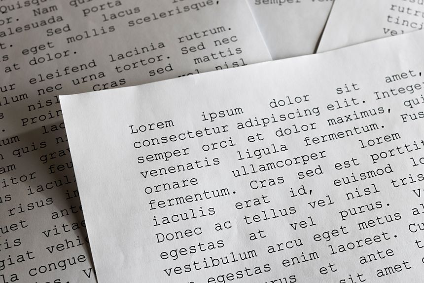 lorem ipsum dolor sit amet concept. selective focus photo of paper sheets with publishing and graphic design placeholder text on them.