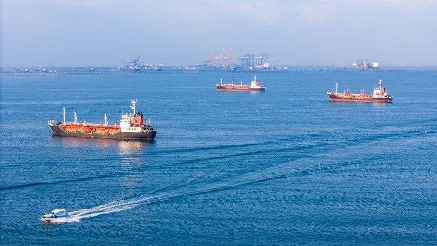 LPG gas and oil tanker ships anchored in the ocean, with a fast patrol boat in the foreground. Global energy transport, war energy crisis, and Strait of Hormuz blockade concept.