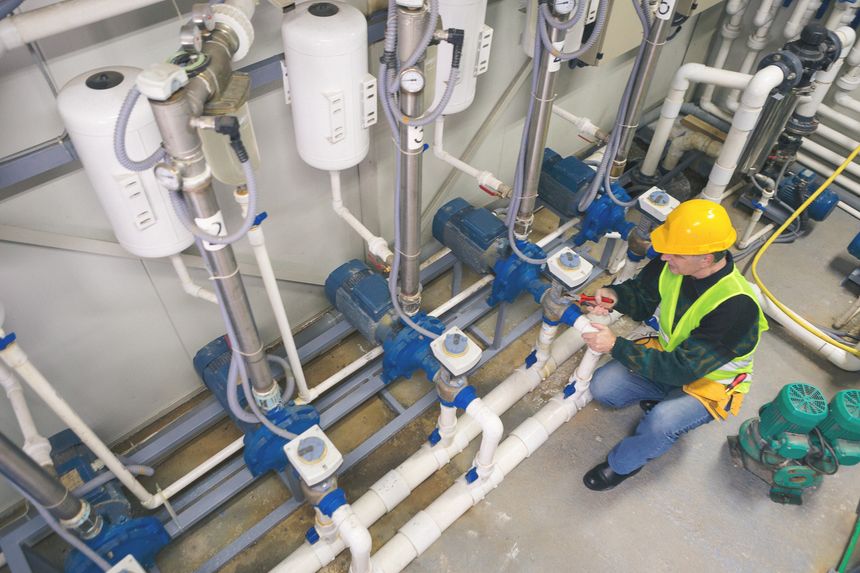 Senior man in a boiler room working. Shallow DOF. Developed from RAW; retouched with special care and attention; Small amount of grain added for best final impression. 16 bit Adobe RGB color profile.