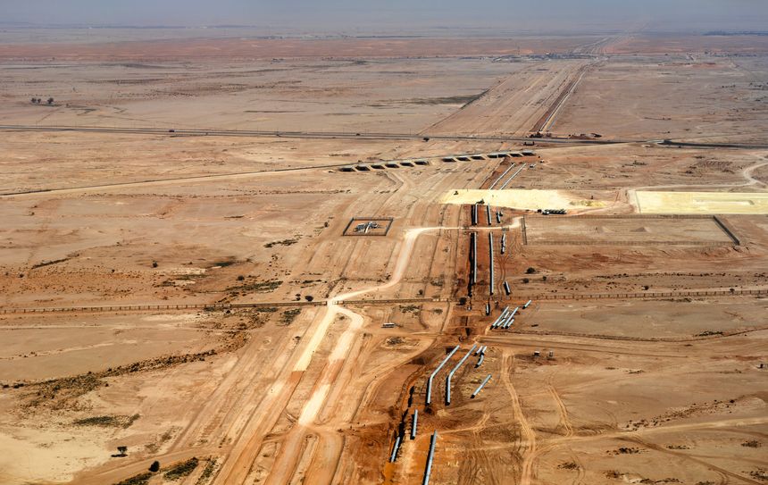 Aerial view of a major pipeline installation and infrastructure project across the arid desert landscape outside Riyadh in Saudi Arabia